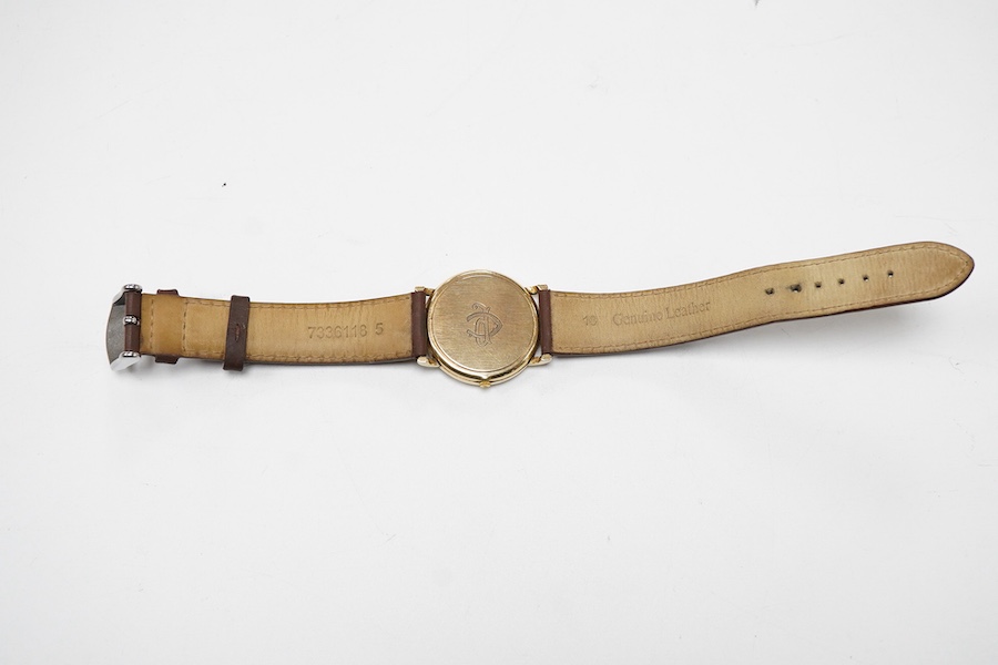 A gentleman's late 20th century Longines 9ct gold quartz wrist watch, with baton numerals and date aperture, the case back with engraved monogram, case diameter 32mm, on an associated leather strap, no box or papers.